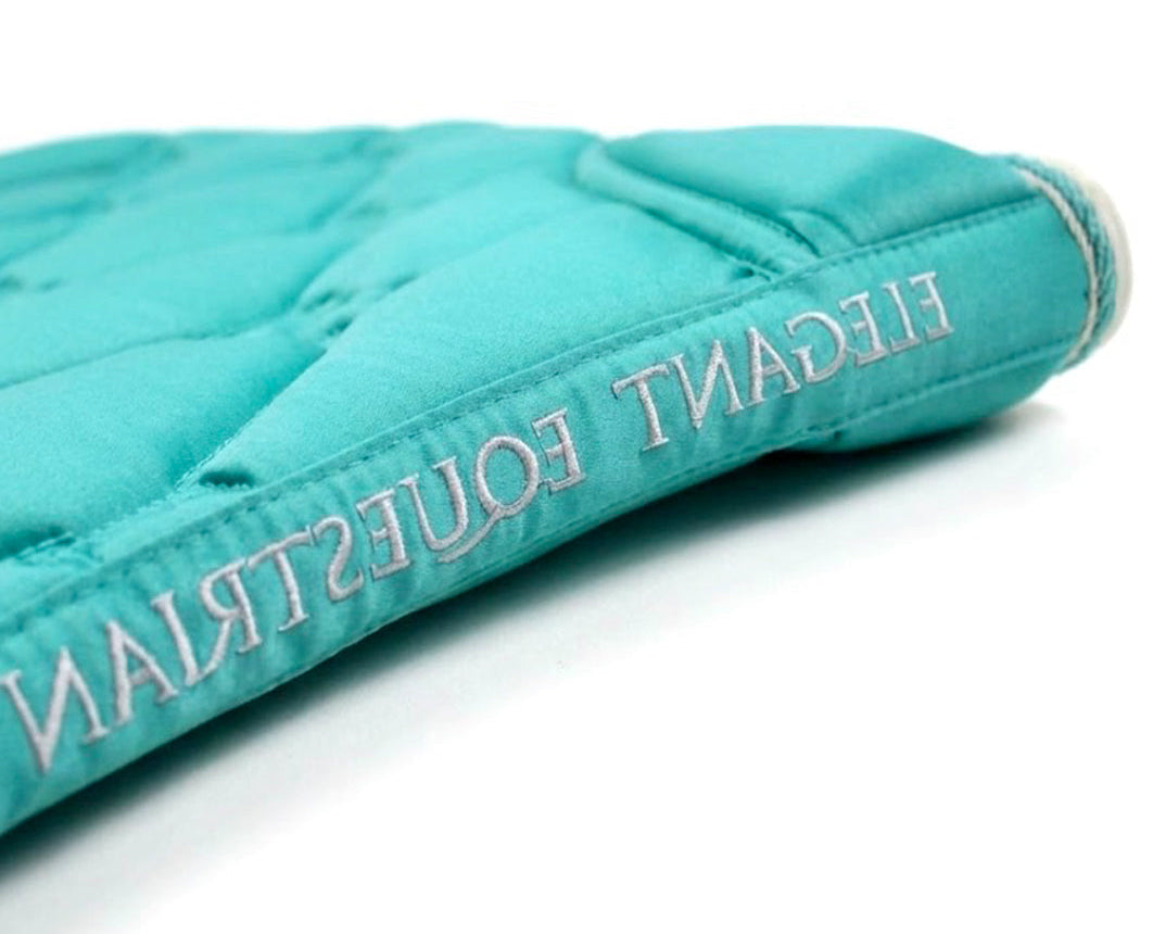 Turquoise equestrian saddle pad with 'Elegant Equestrian' embroidery on a white background